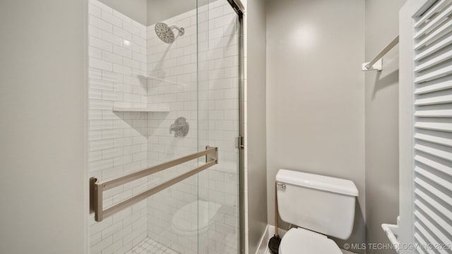 full bath with toilet and a stall shower