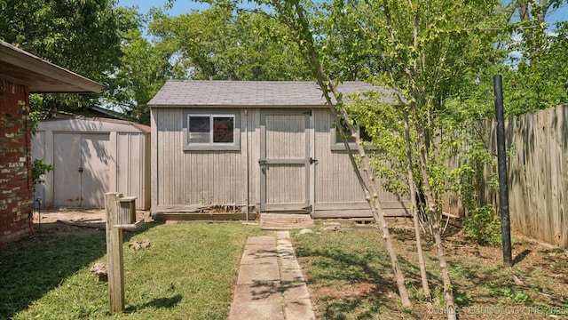 view of shed with fence