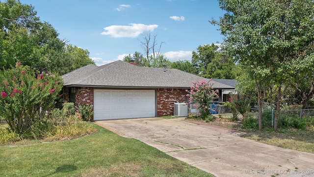 ranch-style home featuring driveway, brick siding, central AC unit, and an attached garage