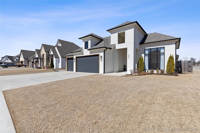 view of front of house with a shingled roof, concrete driveway, a garage, and stucco siding