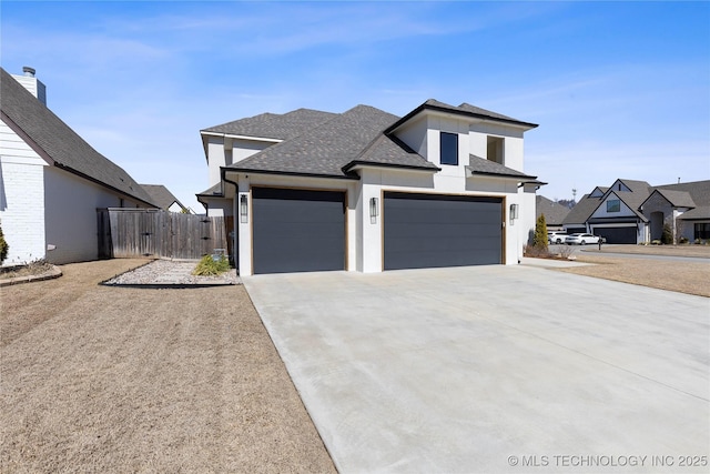 view of front of home featuring driveway, a gate, fence, a shingled roof, and a garage