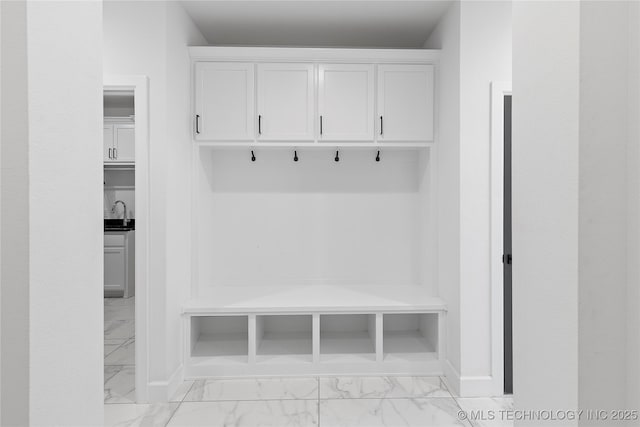 mudroom featuring baseboards and marble finish floor