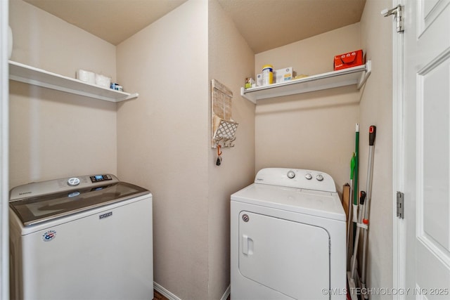 washroom featuring washer and dryer and laundry area