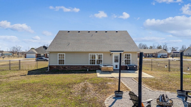 back of house featuring a patio area, a gate, a lawn, and brick siding