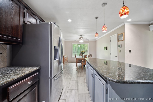 kitchen with pendant lighting, decorative backsplash, dark brown cabinets, and crown molding