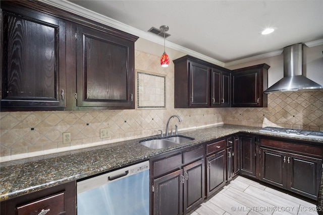 kitchen featuring visible vents, a sink, appliances with stainless steel finishes, crown molding, and wall chimney range hood