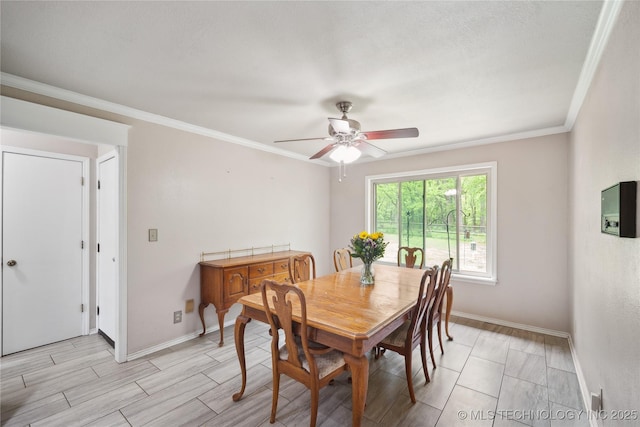 dining area featuring wood tiled floor, a ceiling fan, baseboards, and ornamental molding