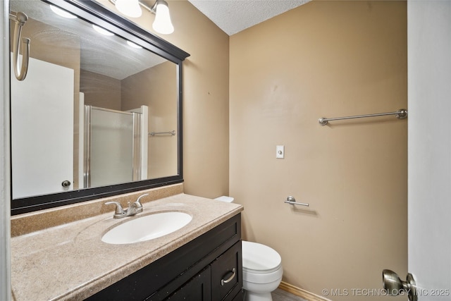 full bath with vanity, toilet, baseboards, and a stall shower