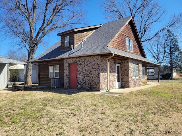 view of side of property with a yard, stone siding, roof with shingles, and central AC