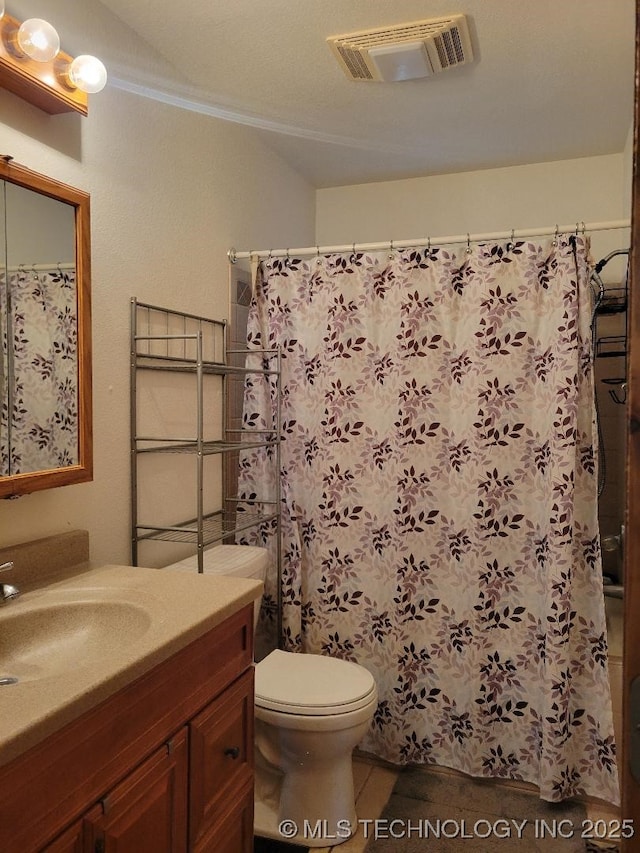 bathroom featuring visible vents, toilet, vanity, and a shower with curtain