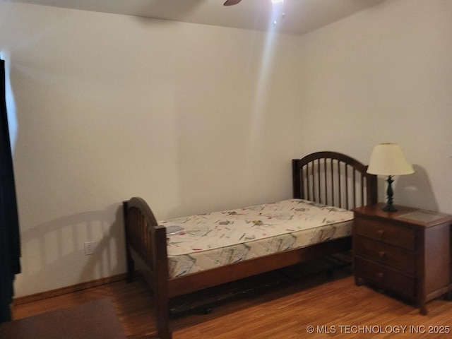 bedroom with ceiling fan and wood finished floors