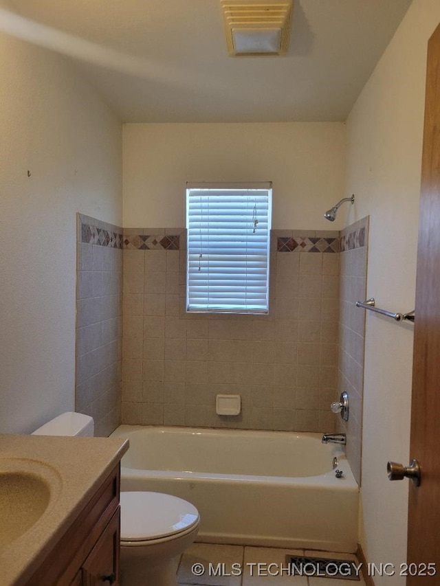 bathroom featuring vanity, toilet, washtub / shower combination, and tile patterned flooring