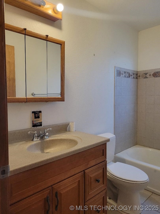 bathroom featuring tile patterned flooring, toilet, and vanity