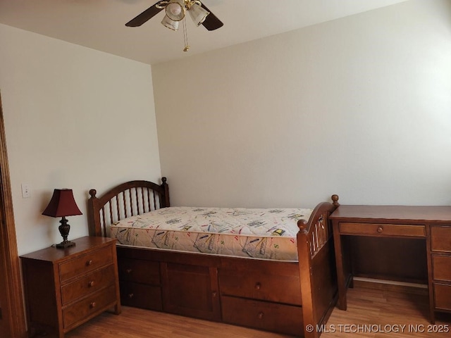 bedroom with wood finished floors and a ceiling fan