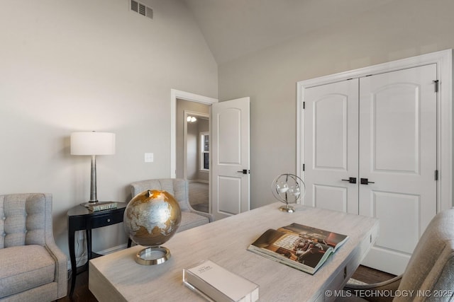 home office with visible vents and vaulted ceiling