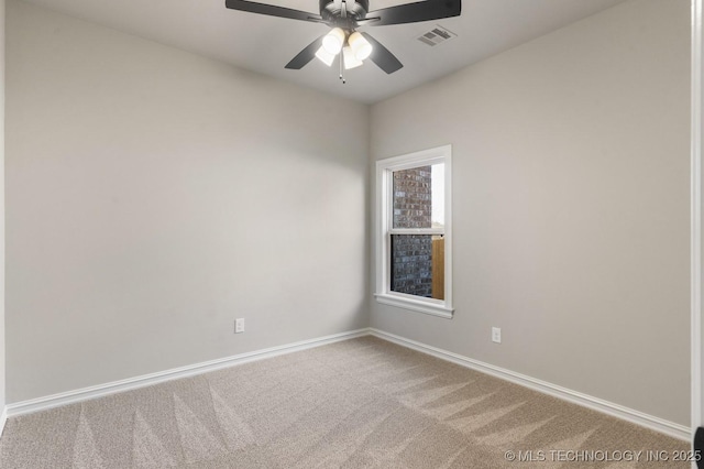 carpeted empty room featuring visible vents, baseboards, and ceiling fan