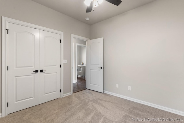 unfurnished bedroom featuring carpet, baseboards, a closet, and ceiling fan