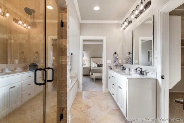 ensuite bathroom with a stall shower, ornamental molding, double vanity, and a sink