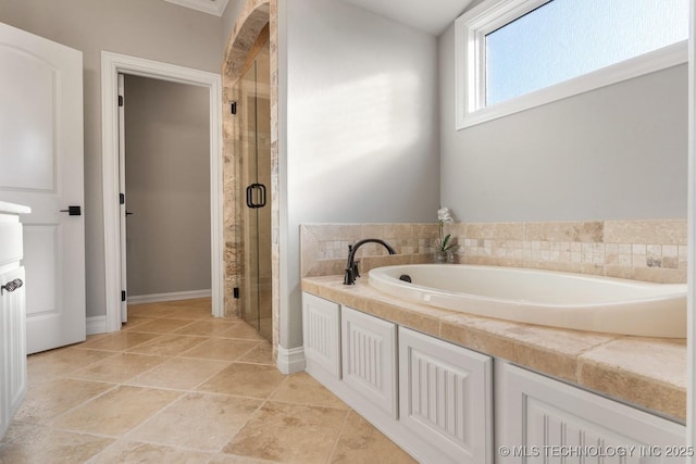 bathroom with a stall shower, a bath, and tile patterned flooring