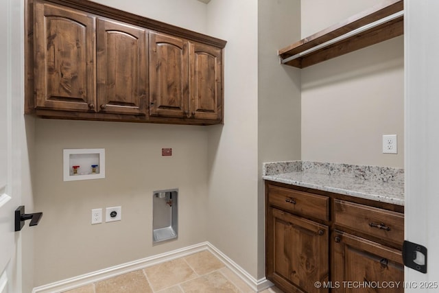 washroom featuring hookup for a washing machine, cabinet space, baseboards, and hookup for an electric dryer