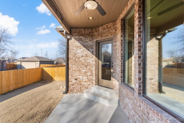 view of patio / terrace with entry steps, a ceiling fan, and fence