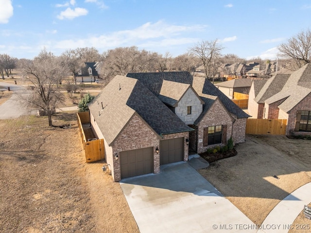 view of front of property with driveway, fence, a shingled roof, a garage, and a chimney