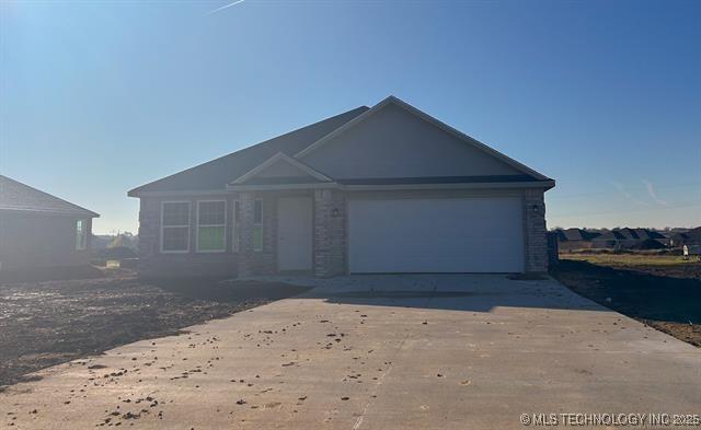 view of front of home with an attached garage and concrete driveway