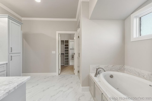 full bath featuring marble finish floor, a jetted tub, crown molding, and baseboards