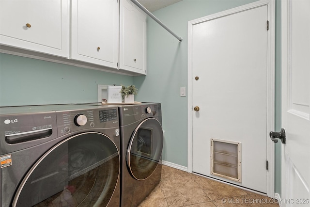 washroom with washer and clothes dryer, light tile patterned floors, cabinet space, and baseboards