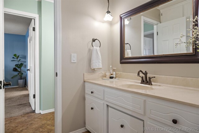 bathroom with baseboards and vanity