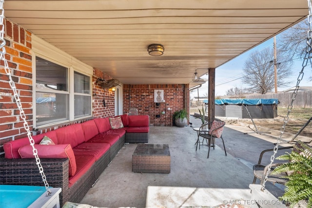 view of patio with outdoor lounge area and fence