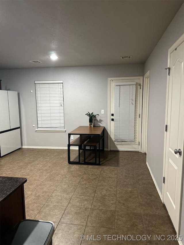 interior space featuring visible vents, baseboards, and tile patterned flooring