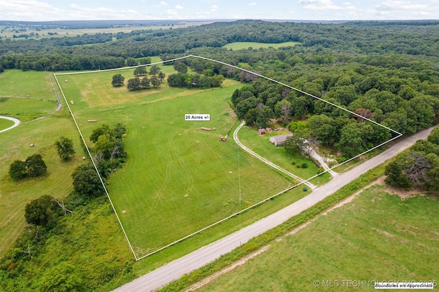 drone / aerial view with a rural view and a wooded view