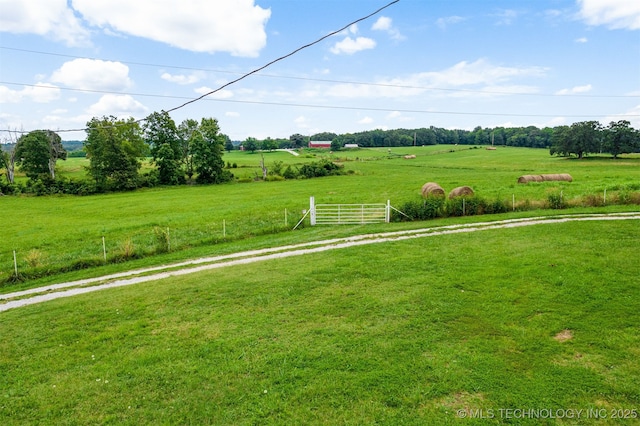 view of yard with a rural view and fence