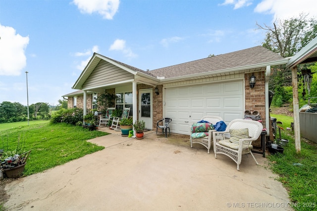 view of front of house featuring a garage, brick siding, roof with shingles, and a front lawn