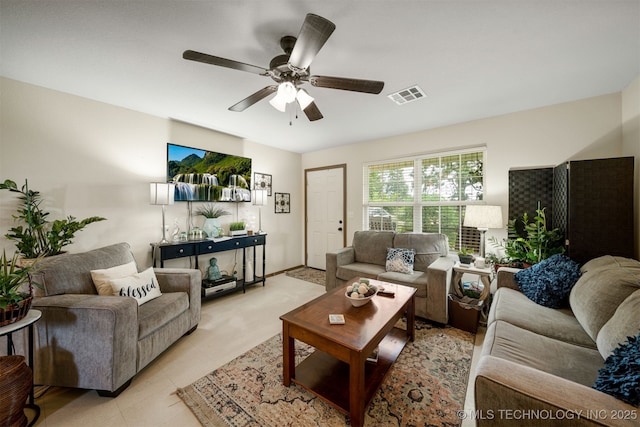 living area featuring light tile patterned floors, visible vents, and ceiling fan