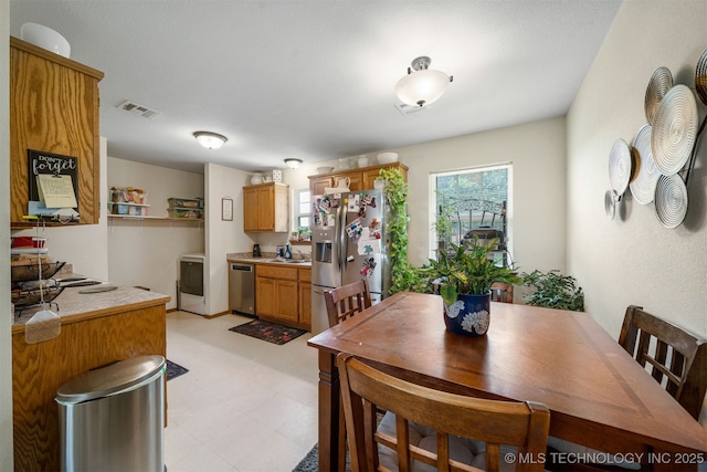 dining area with visible vents and light floors