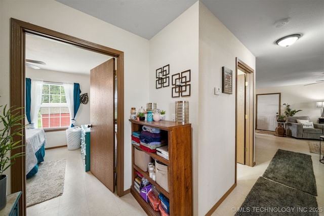 hallway featuring baseboards