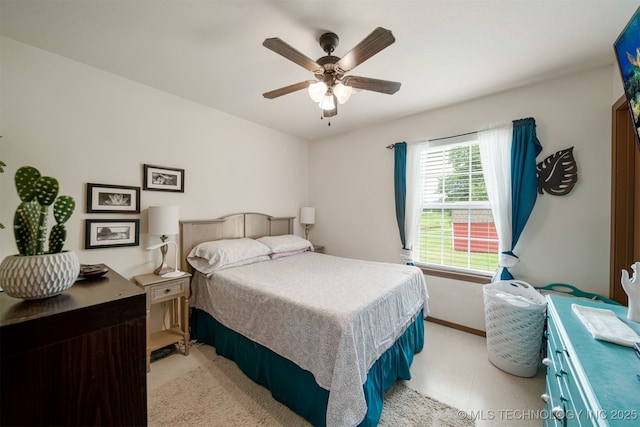 bedroom featuring a ceiling fan and baseboards