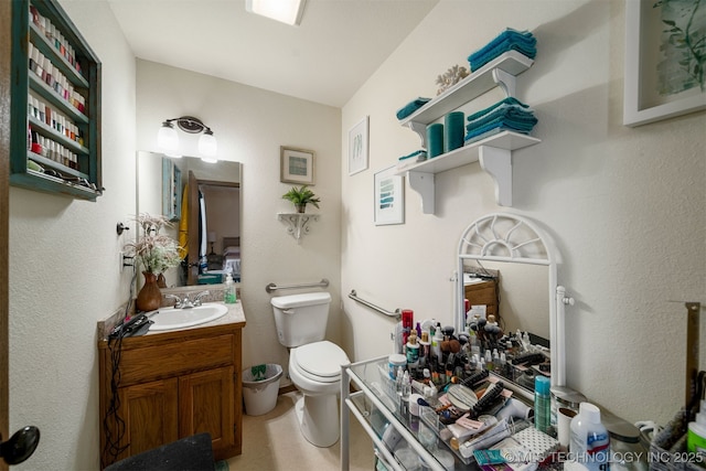 bathroom featuring toilet and vanity