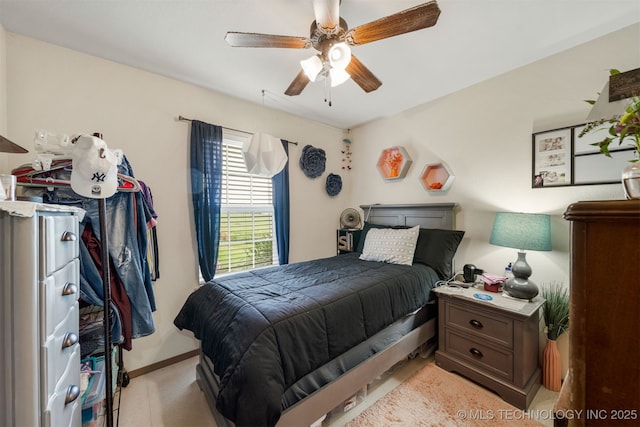 bedroom featuring baseboards and a ceiling fan