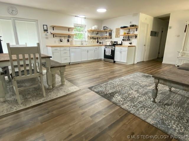 kitchen with white appliances, white cabinets, wood finished floors, and open shelves