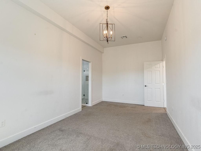empty room featuring visible vents, carpet floors, a notable chandelier, and baseboards