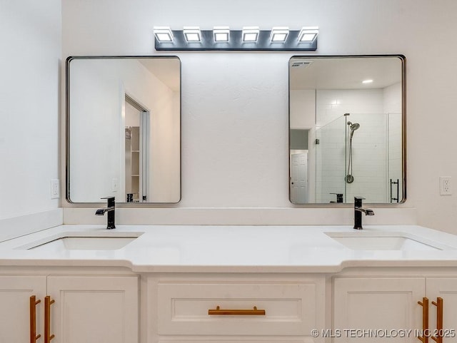 full bath featuring double vanity, a shower stall, and a sink