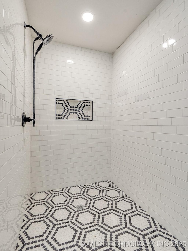 full bath with a tile shower