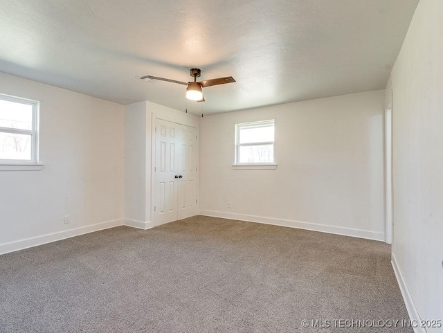empty room featuring baseboards, carpet, and ceiling fan