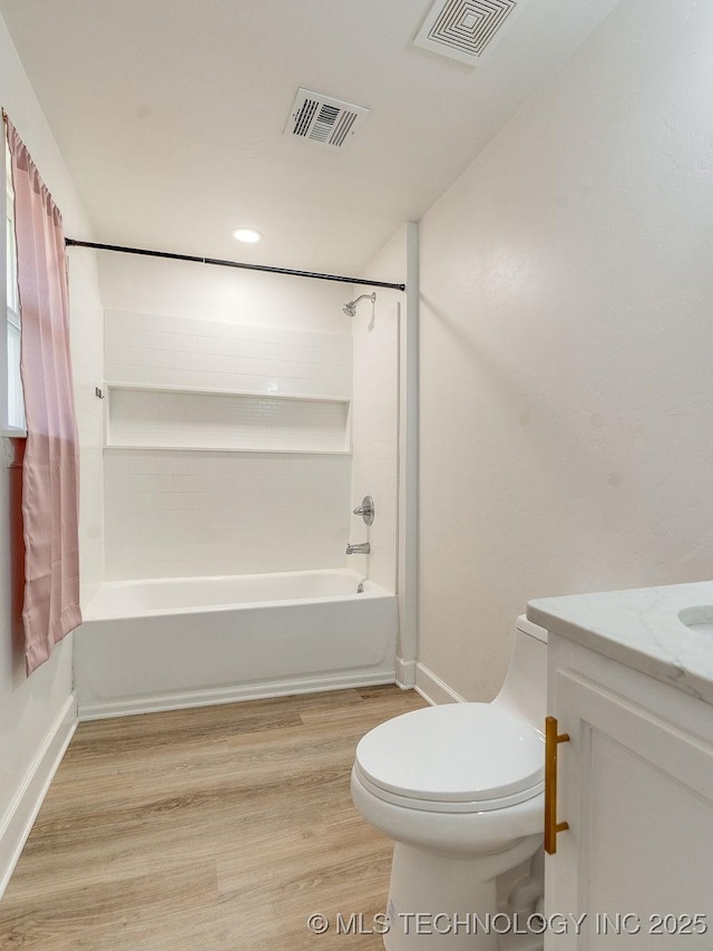 full bathroom with visible vents, toilet, wood finished floors, and vanity