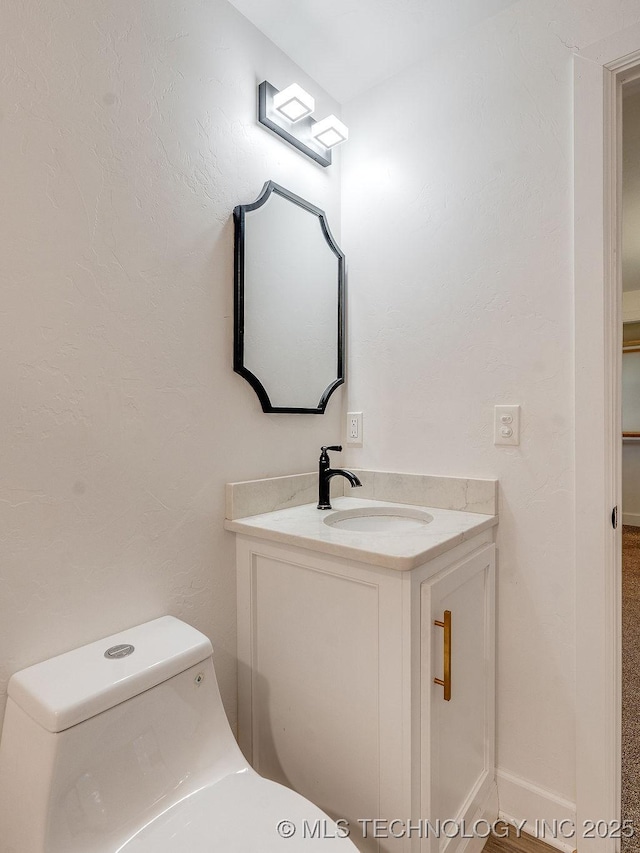 half bath with vanity and toilet