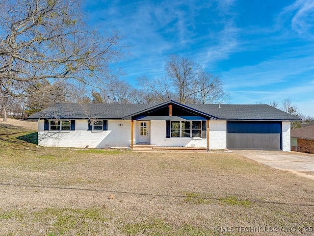 ranch-style home with concrete driveway and a front yard