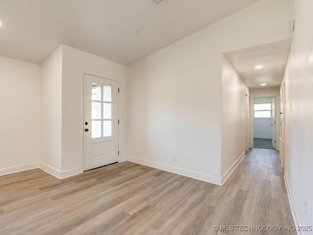 interior space featuring light wood-style flooring and baseboards